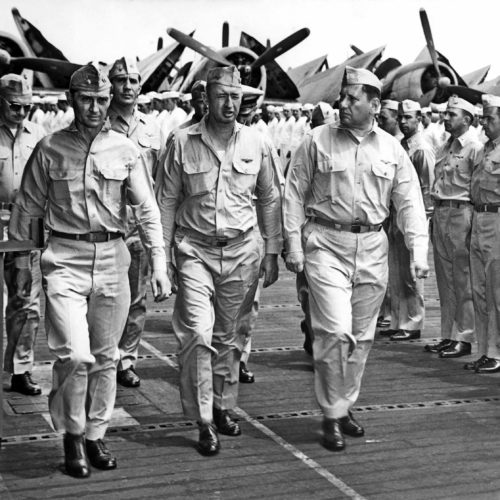 RADM. Joseph J. Clark, USN (center) CAPT. William D. Sample, USN (starboard) and CDR. C. H. Duarfield, USN at inspection of crew aboard USS Hornet (CV-12).