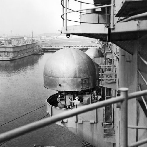 A crane lifting DH dome from a gun tub aboard the USS Hornet (CV-12) during reactivation.