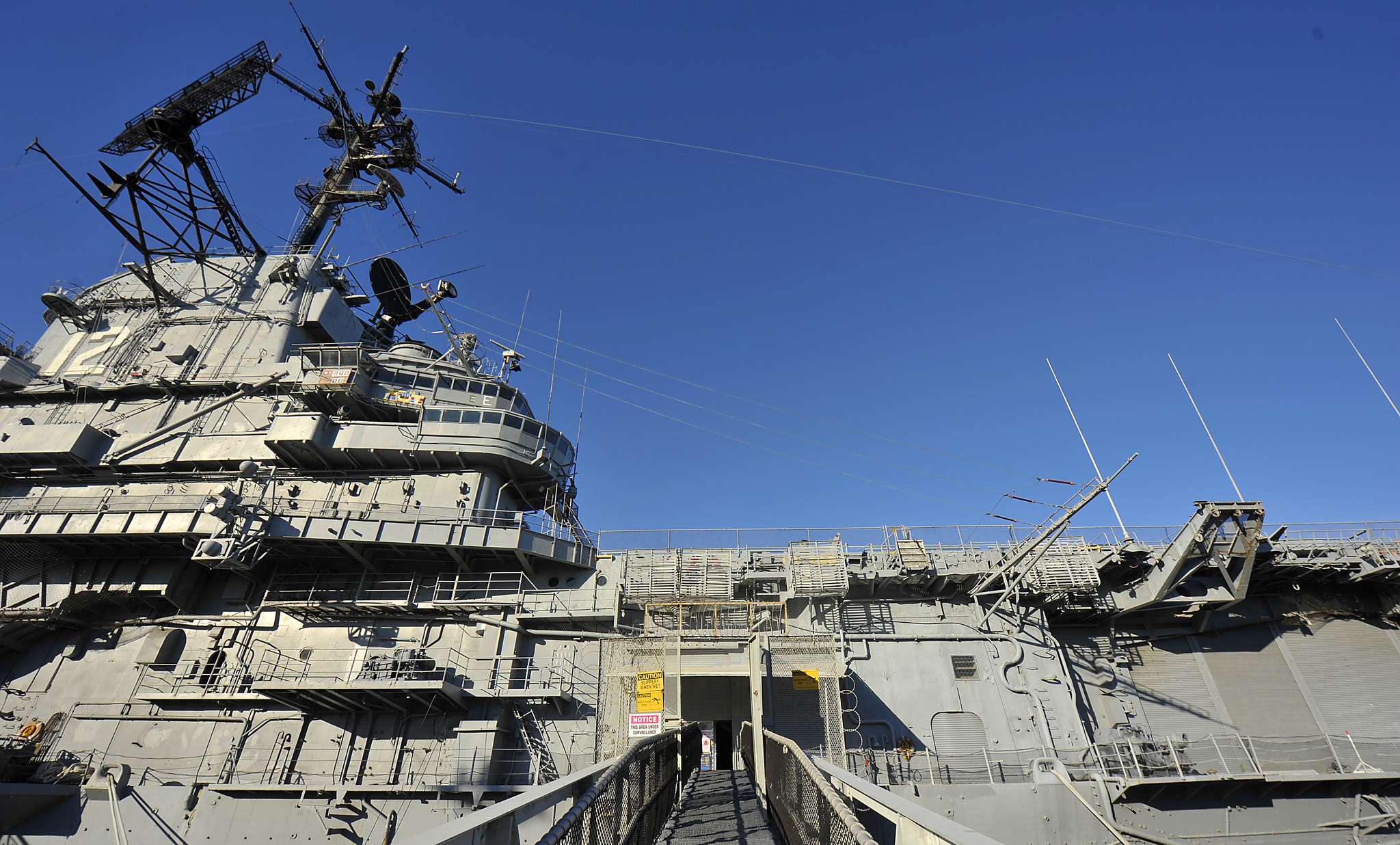 USS Hornet aircraft carrier superstructure with antennas and radar.