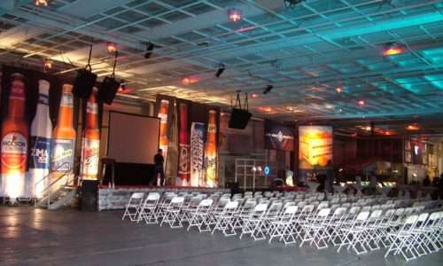 Event hall with beer promotional banners and arranged seating.