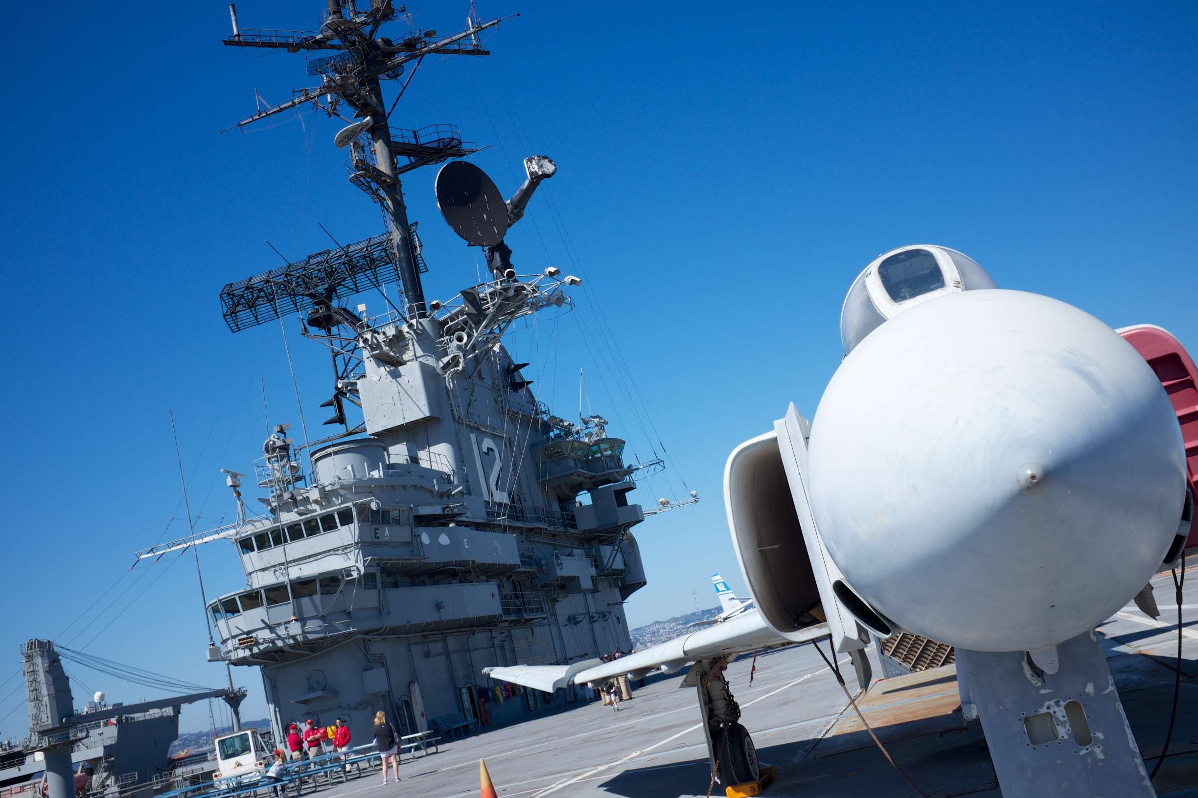 A fighter jet parked on the deck of an aircraft carrier.