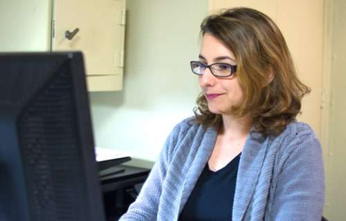 Woman wearing glasses using a computer