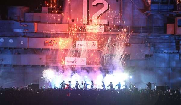 Spectacular nighttime fireworks display on USS Hornet ship deck.