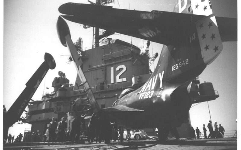 Navy plane on deck of aircraft carrier USS Hornet CVA-12, black and white photo.