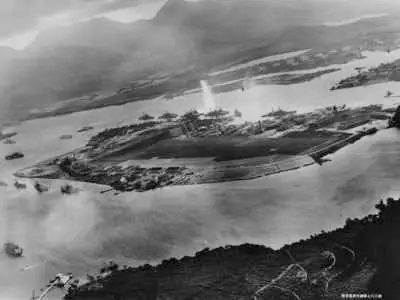 Photograph taken from a Japanese plane during the torpedo attack on ships moored on both sides of Ford Island, Pearl Harbor. U.S. Naval History and Heritage Command Photograph.