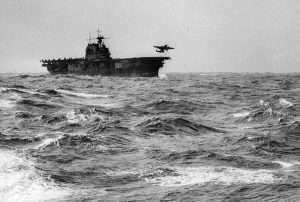 USS Hornet in rough seas with plane landing