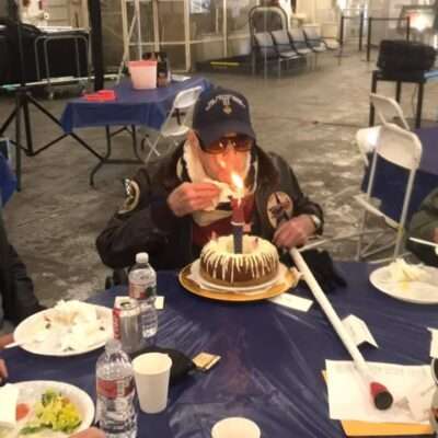 Veteran Diz Laird celebrating 98th birthday with cake on USS Hornet.